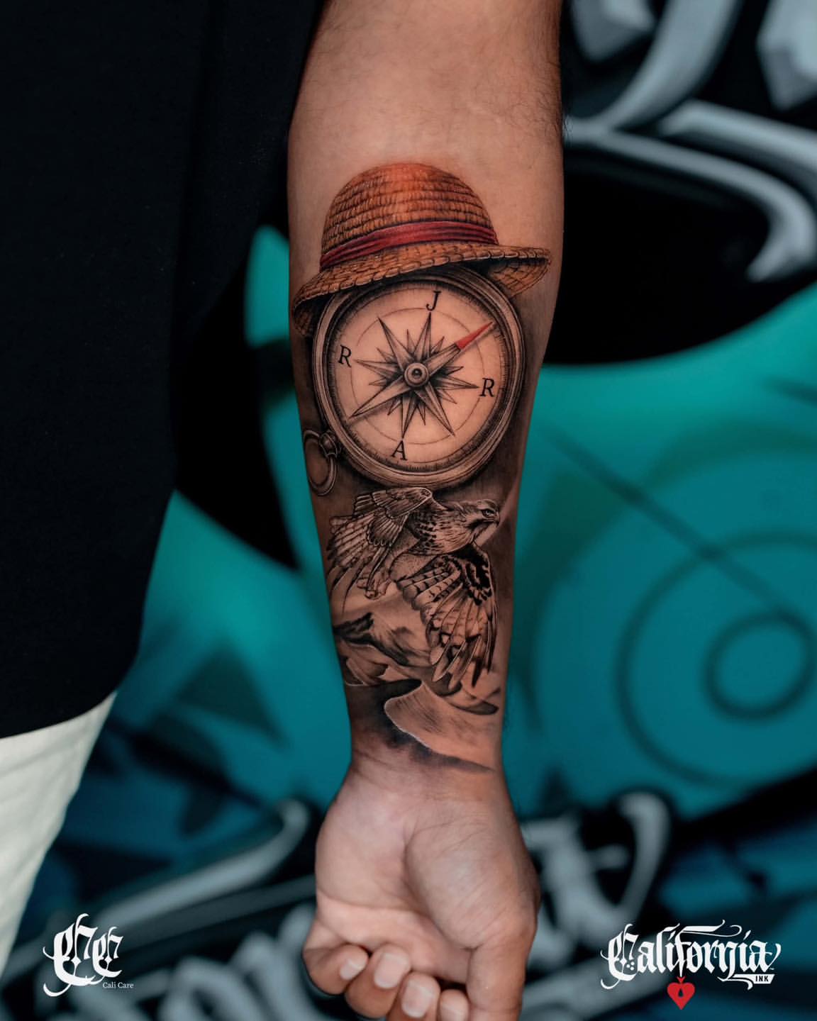 Compass with straw hat and eagle on forearm, rendered in black and grey with realistic shading and detail.