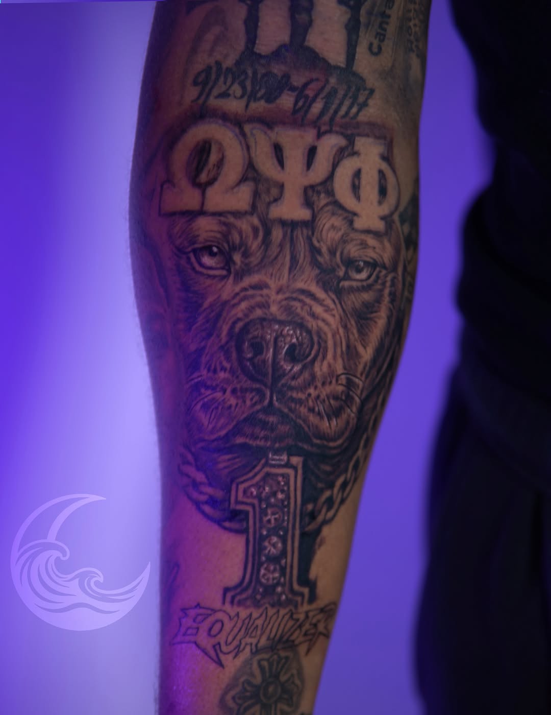 Bearded man's face with Greek letters and ornamental numbers on a forearm in black and grey with soft shading.