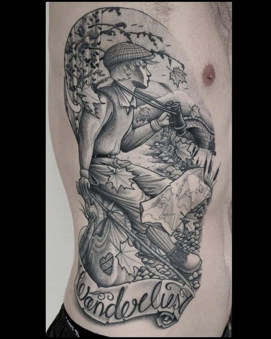 Black and grey shoulder tattoo featuring a hunter in a cap with rifle surrounded by autumn leaves, map, and forest scenery with text below.