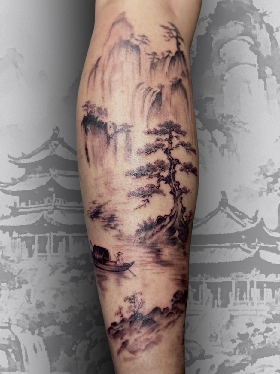 Asian landscape tattoo on forearm featuring misty mountains, waterfall, gnarled tree, and small boat in black and grey shading.