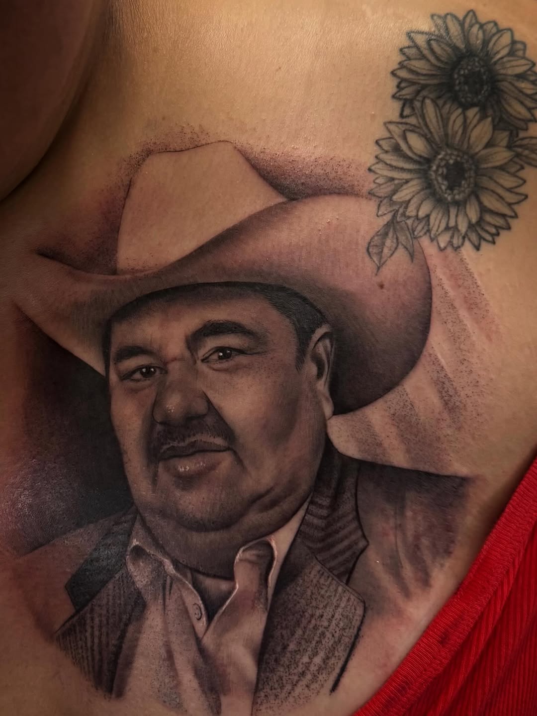 Portrait of a man wearing a cowboy hat and western shirt with two sunflowers above on chest, rendered in black and grey with smooth shading.