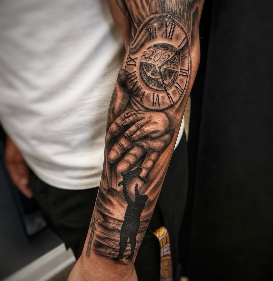 Full forearm tattoo featuring a Roman numeral clock showing 2024 above a realistic hand holding a silhouetted figure, rendered in black and grey shading.